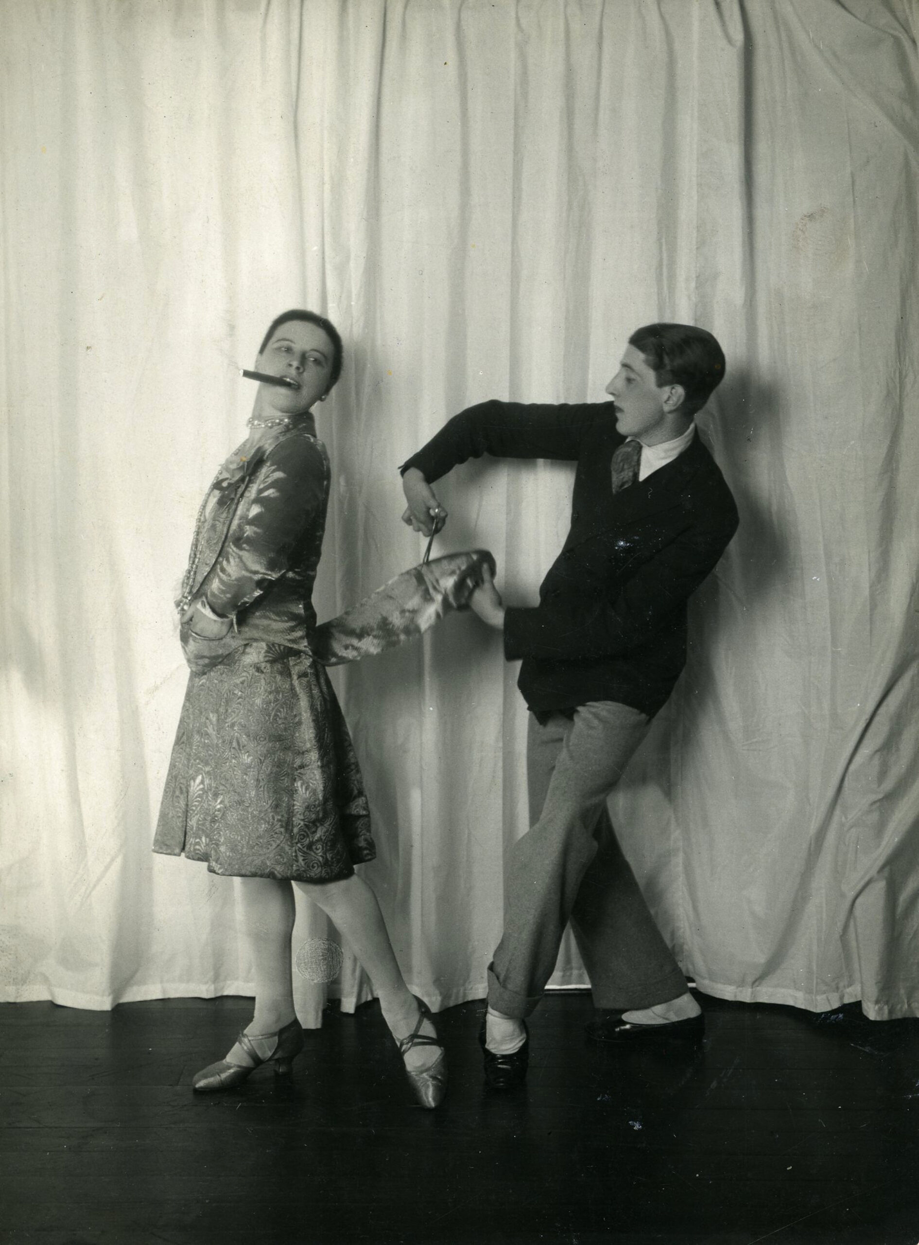 An old photo of a man and a woman dancing.