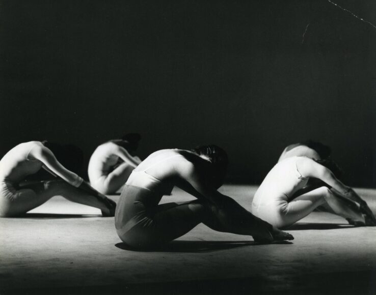 A black and white photo of a group of dancers.