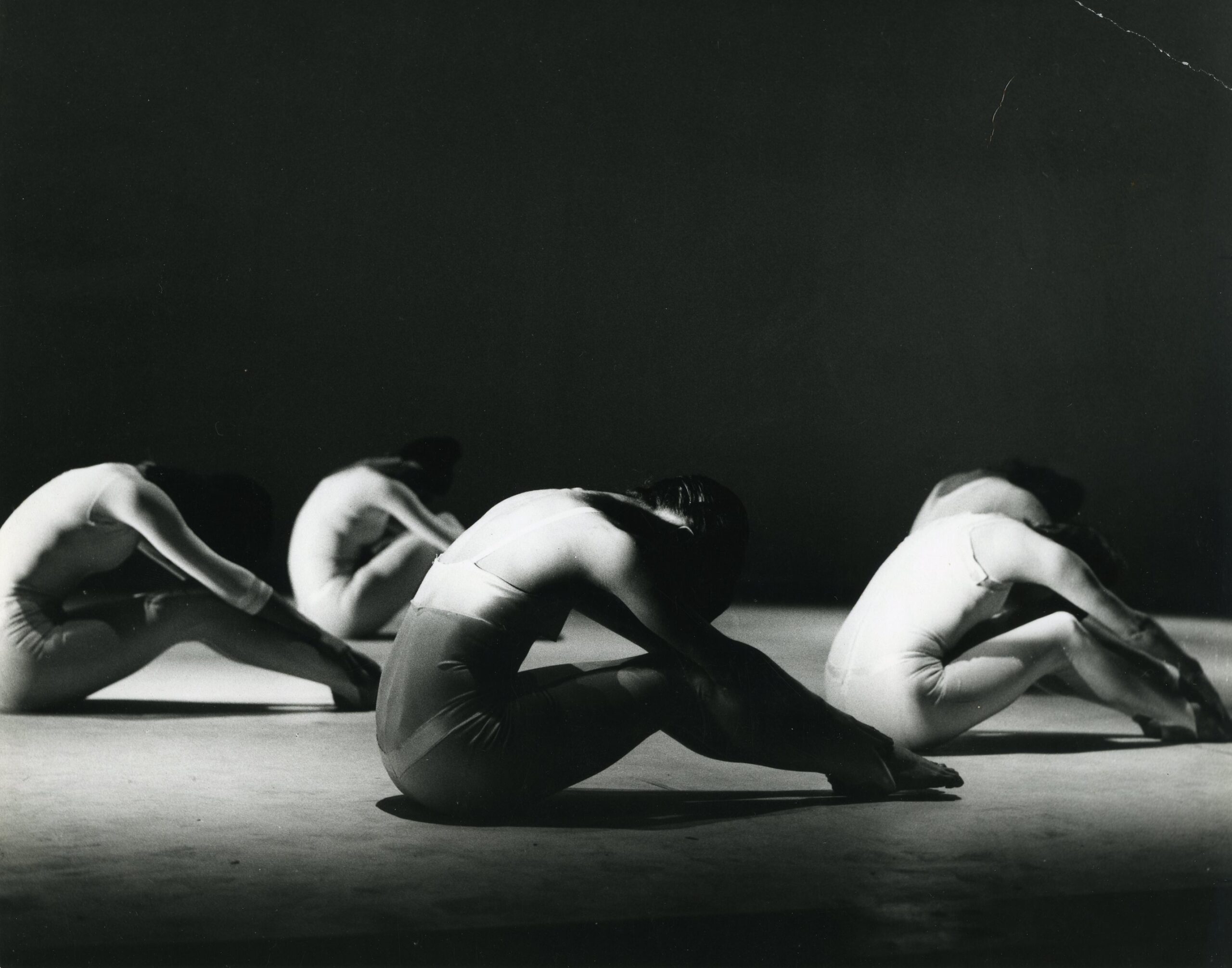 A black and white photo of a group of dancers.