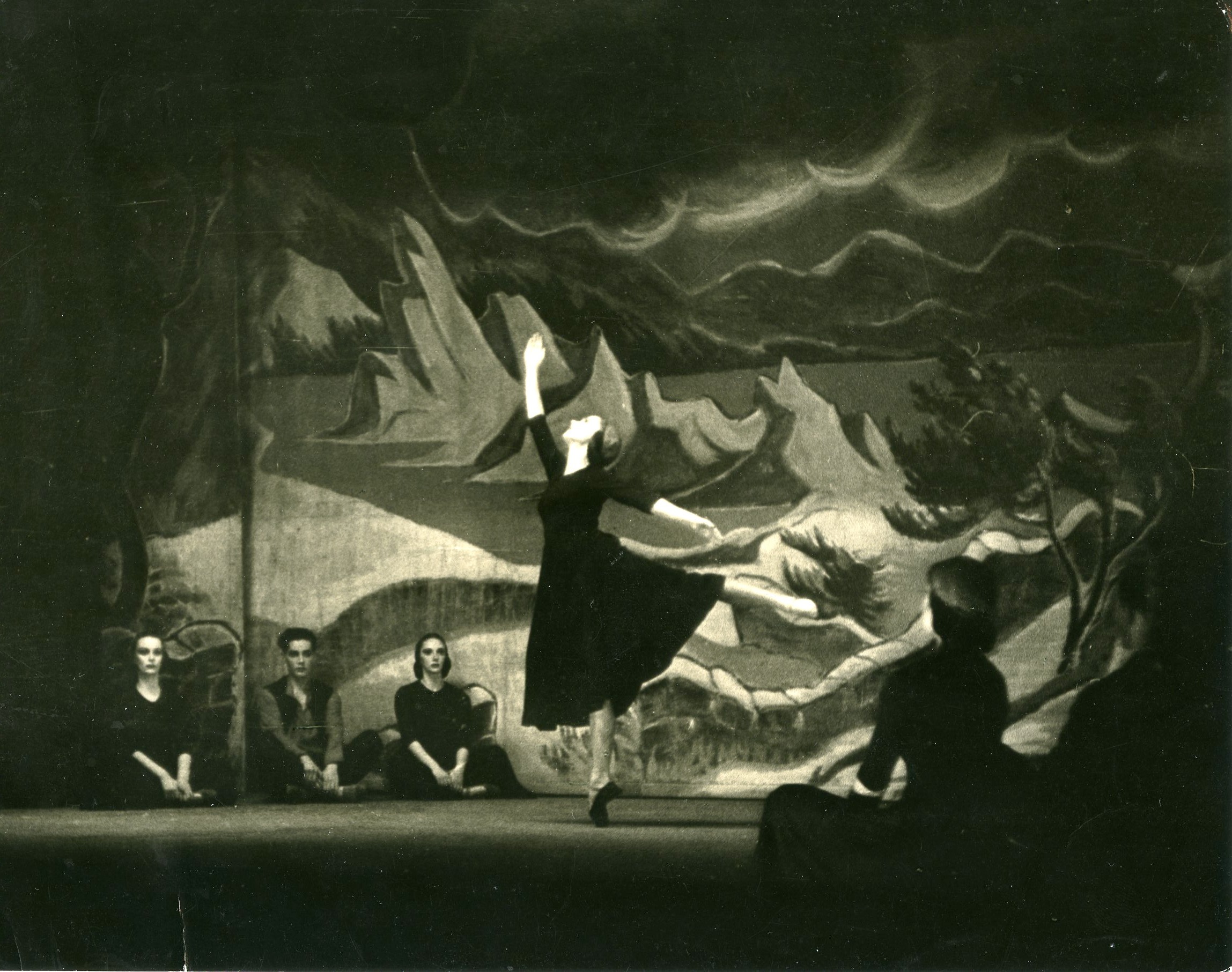 A black and white photo of a dancer on stage.