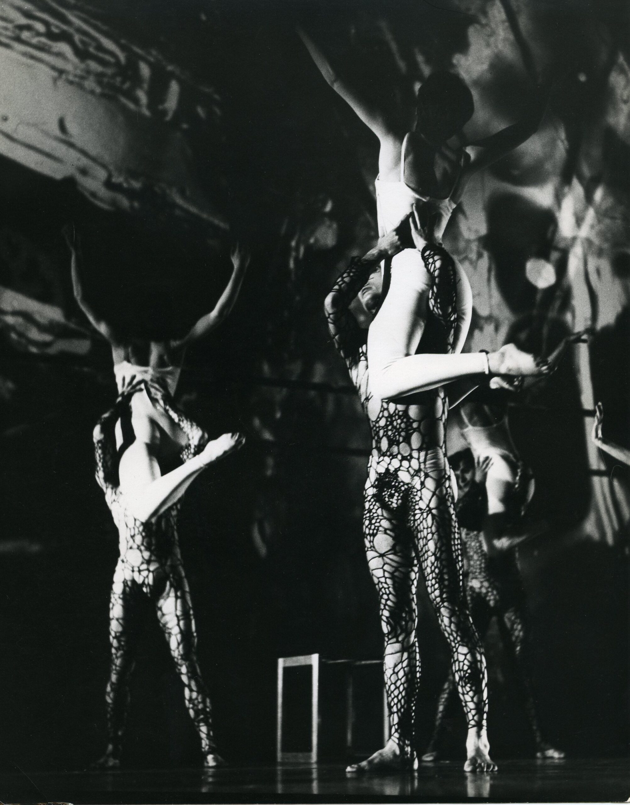 A black and white photo of a group of dancers on stage.