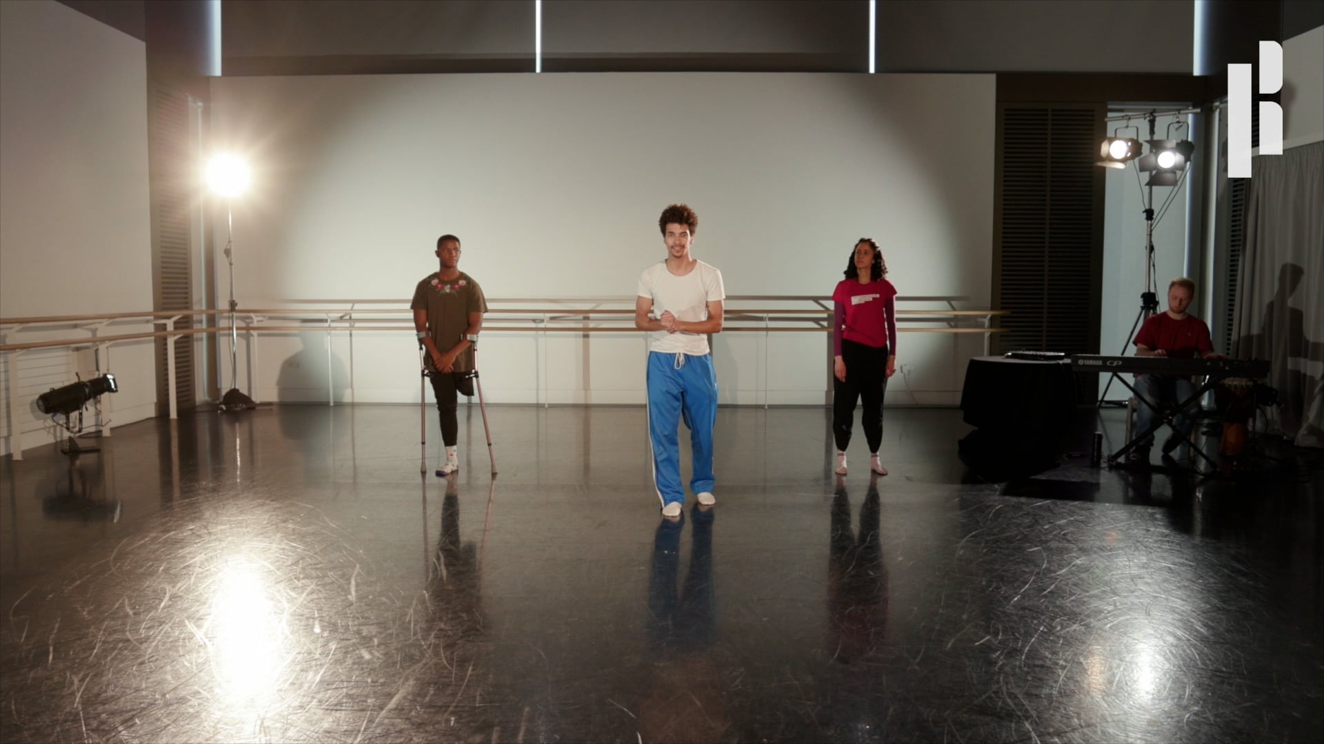 A group of people standing in a dance studio.