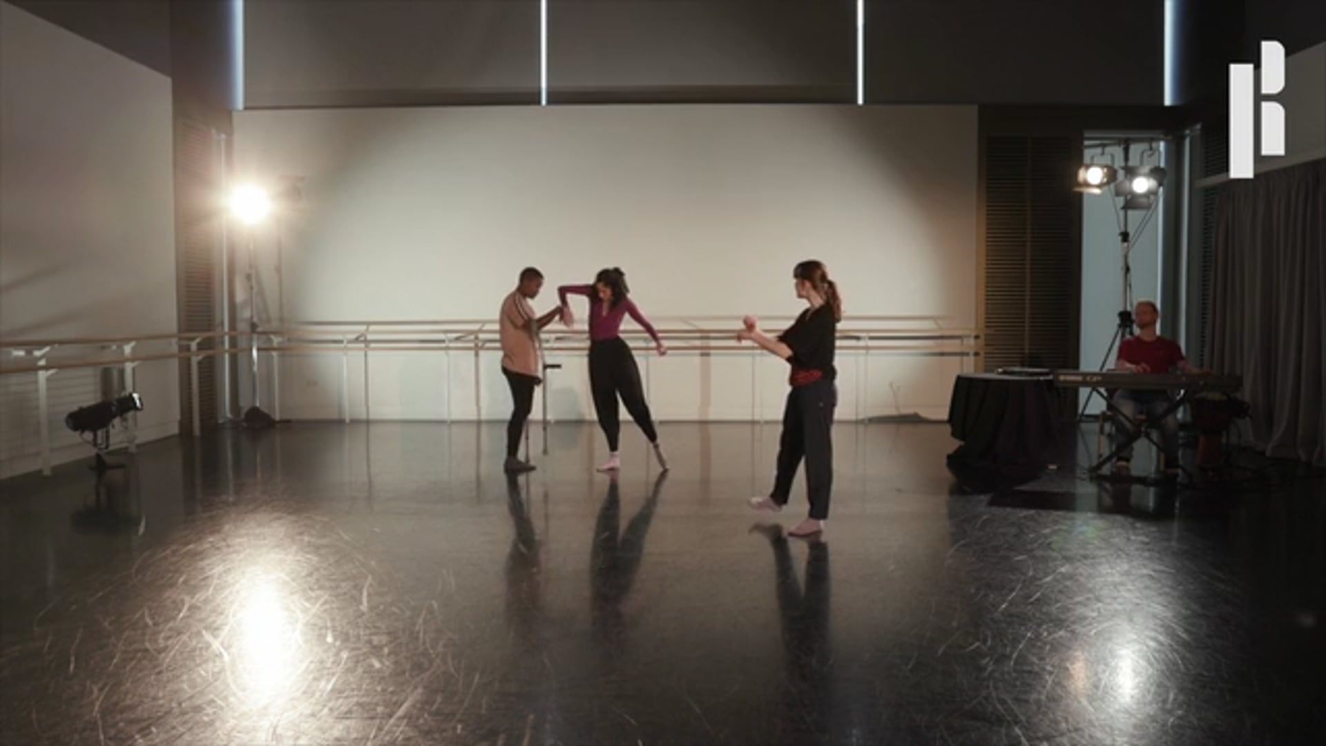 A group of dancers in an empty dance studio.