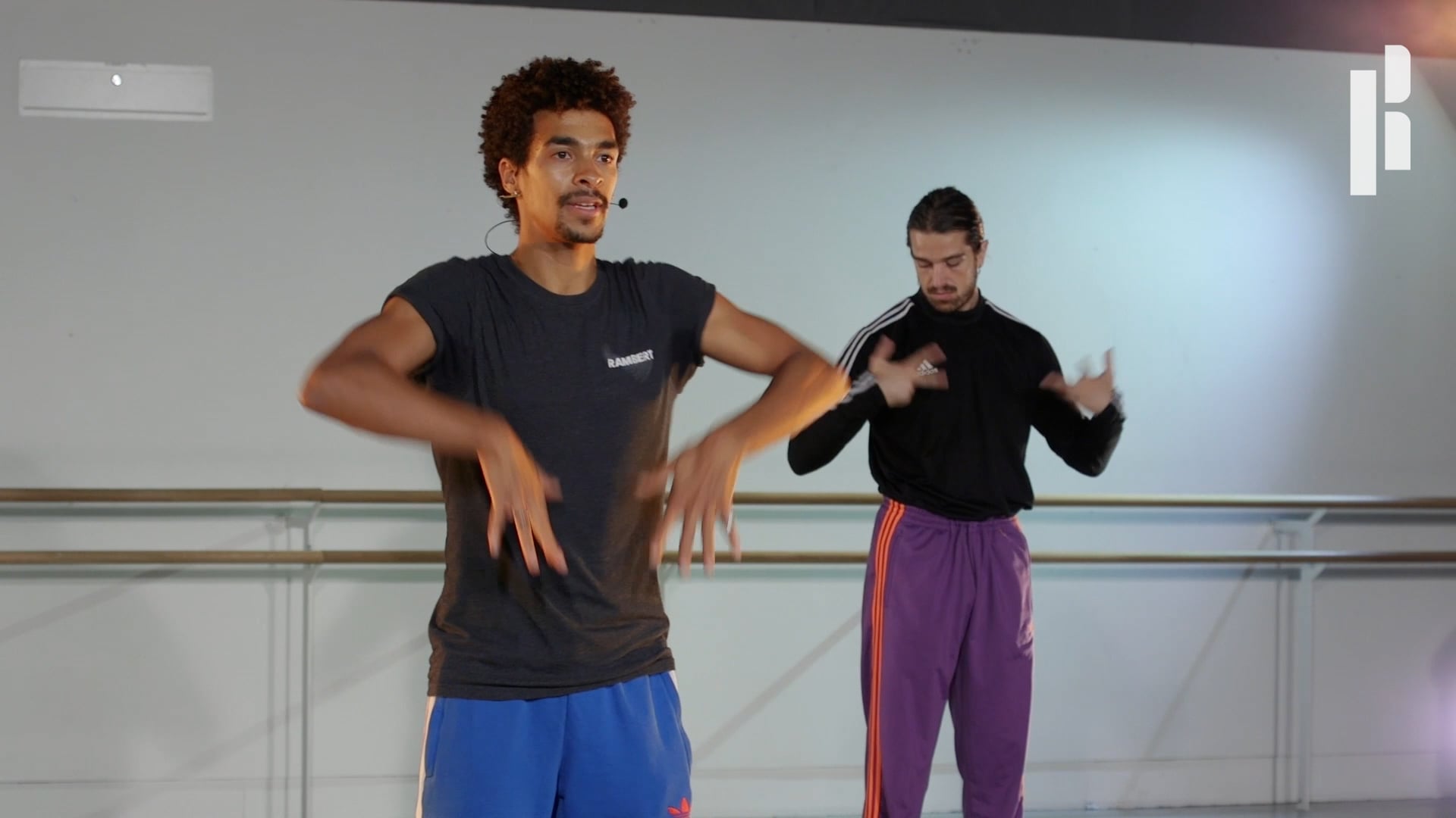 Two men are dancing in a dance studio.