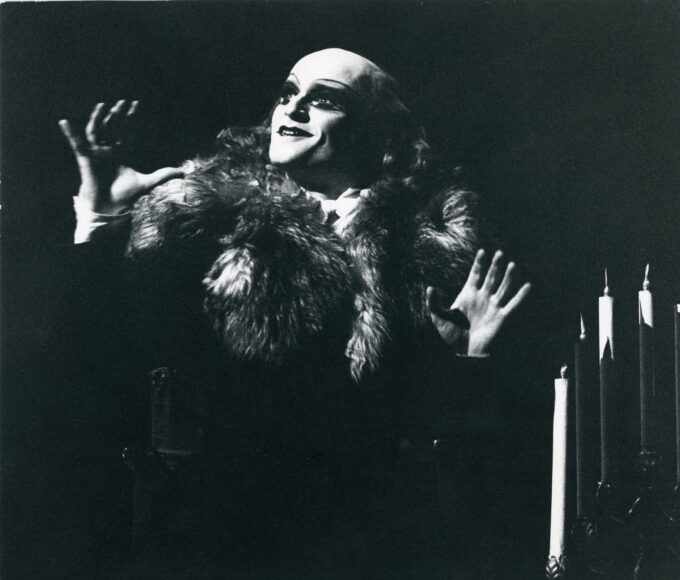 A black and white photo of a man in a fur coat.