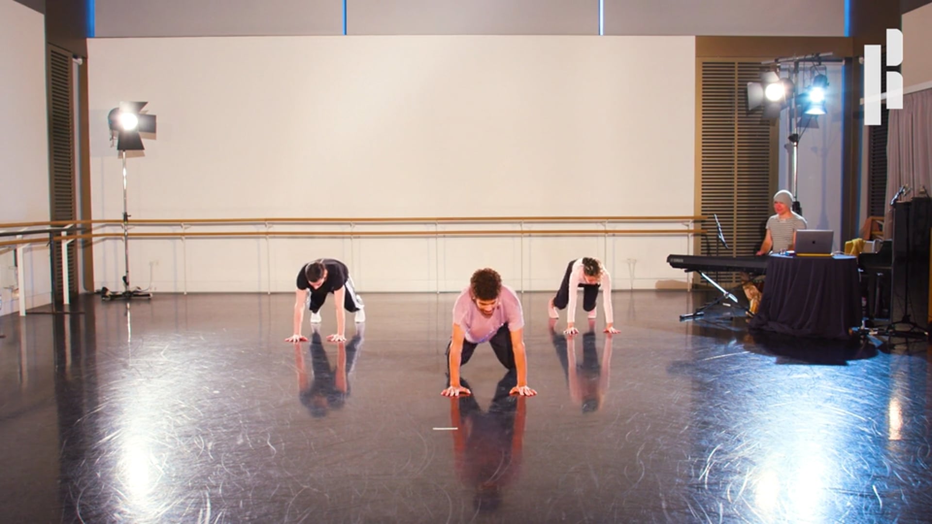 A group of dancers practicing in a dance studio.