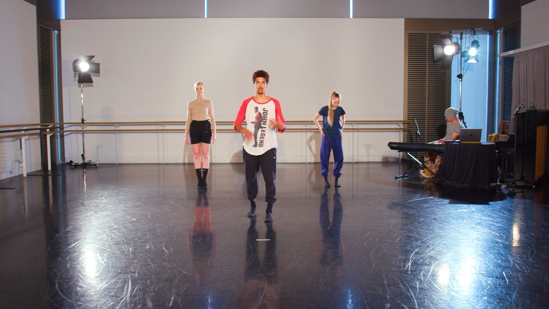 A group of dancers in an empty dance studio.