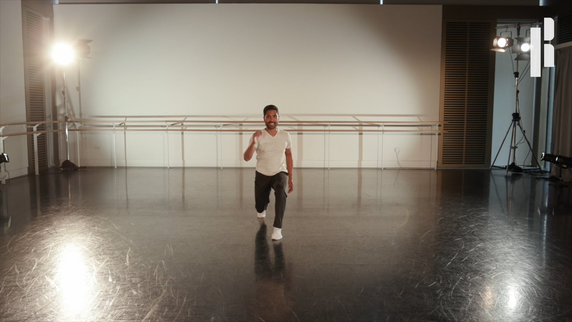A man is dancing in a dance studio.