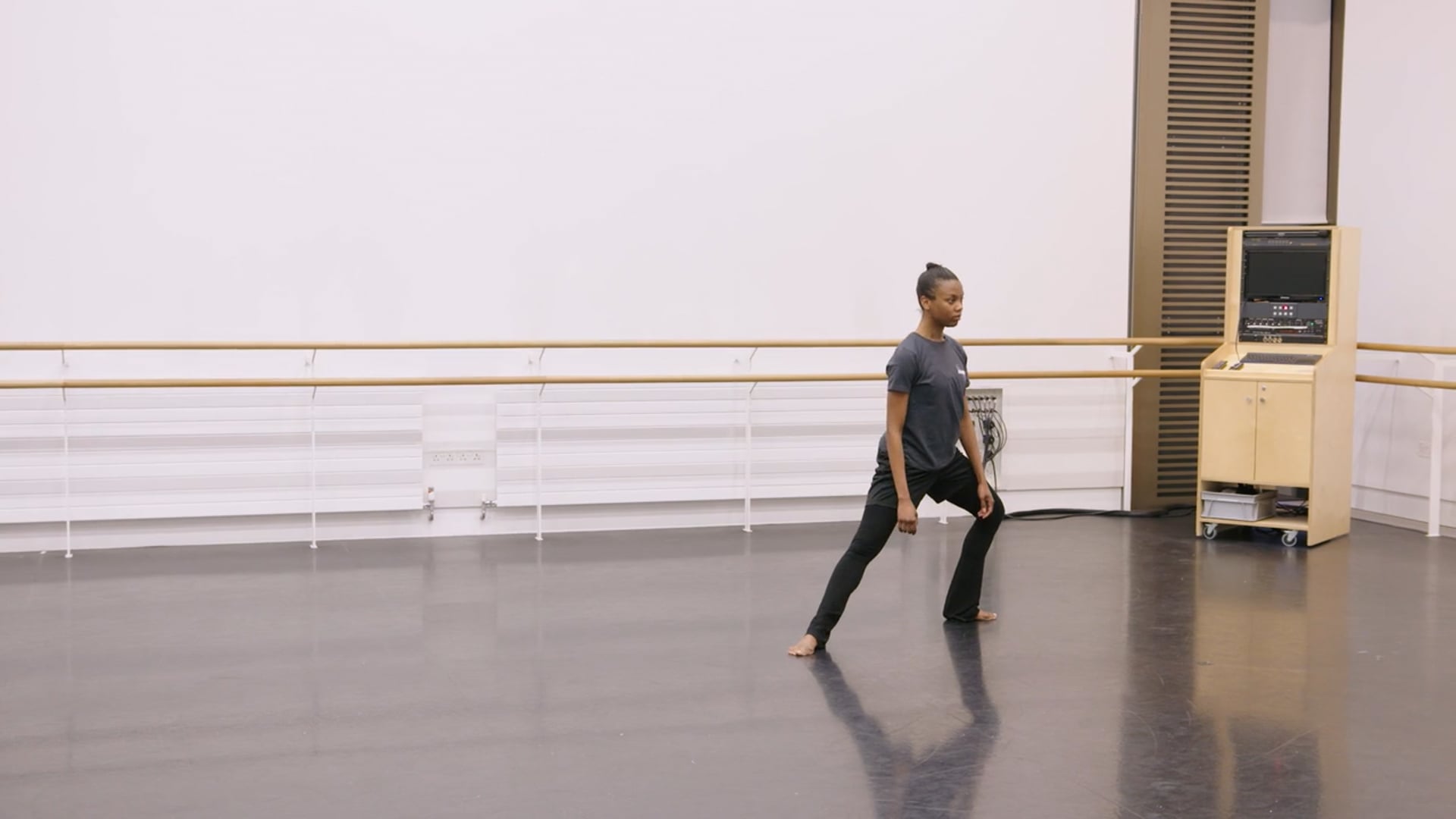 A young dancer practicing in a dance studio.