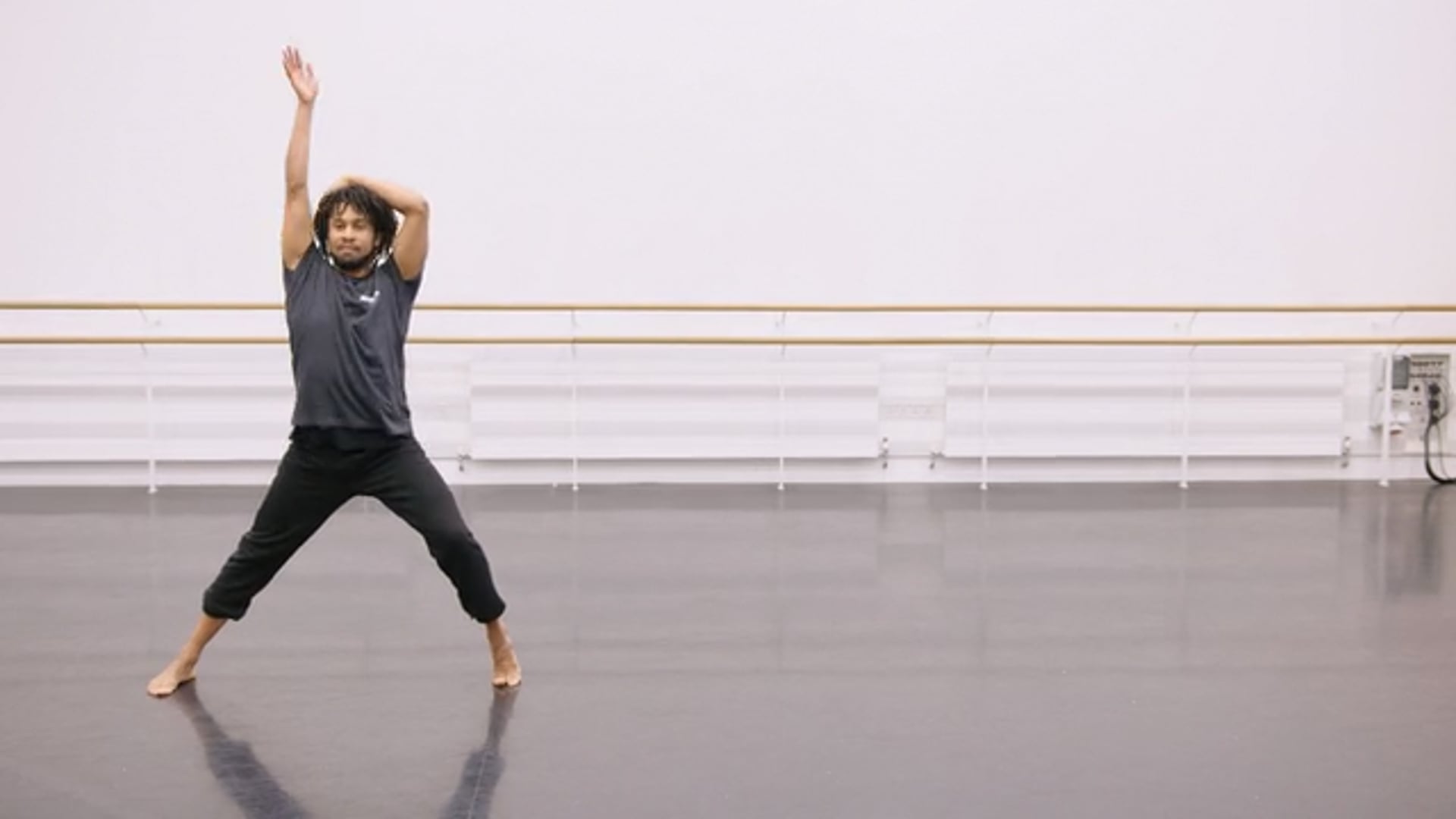 A young dancer practicing in a dance studio.