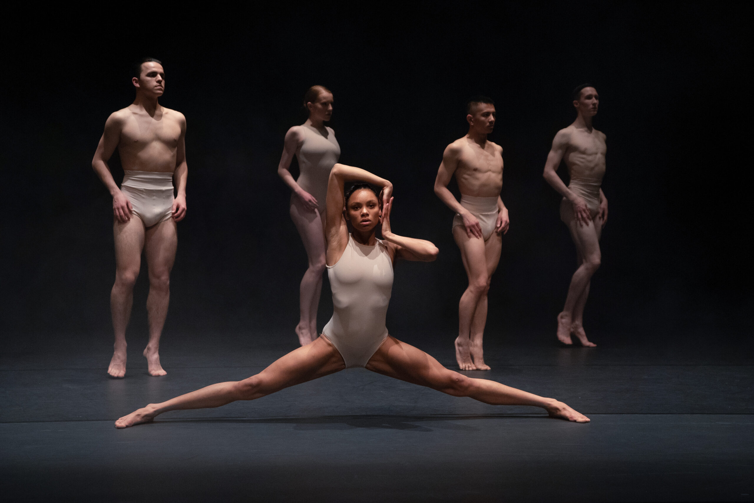 a group of men and women in leotards.