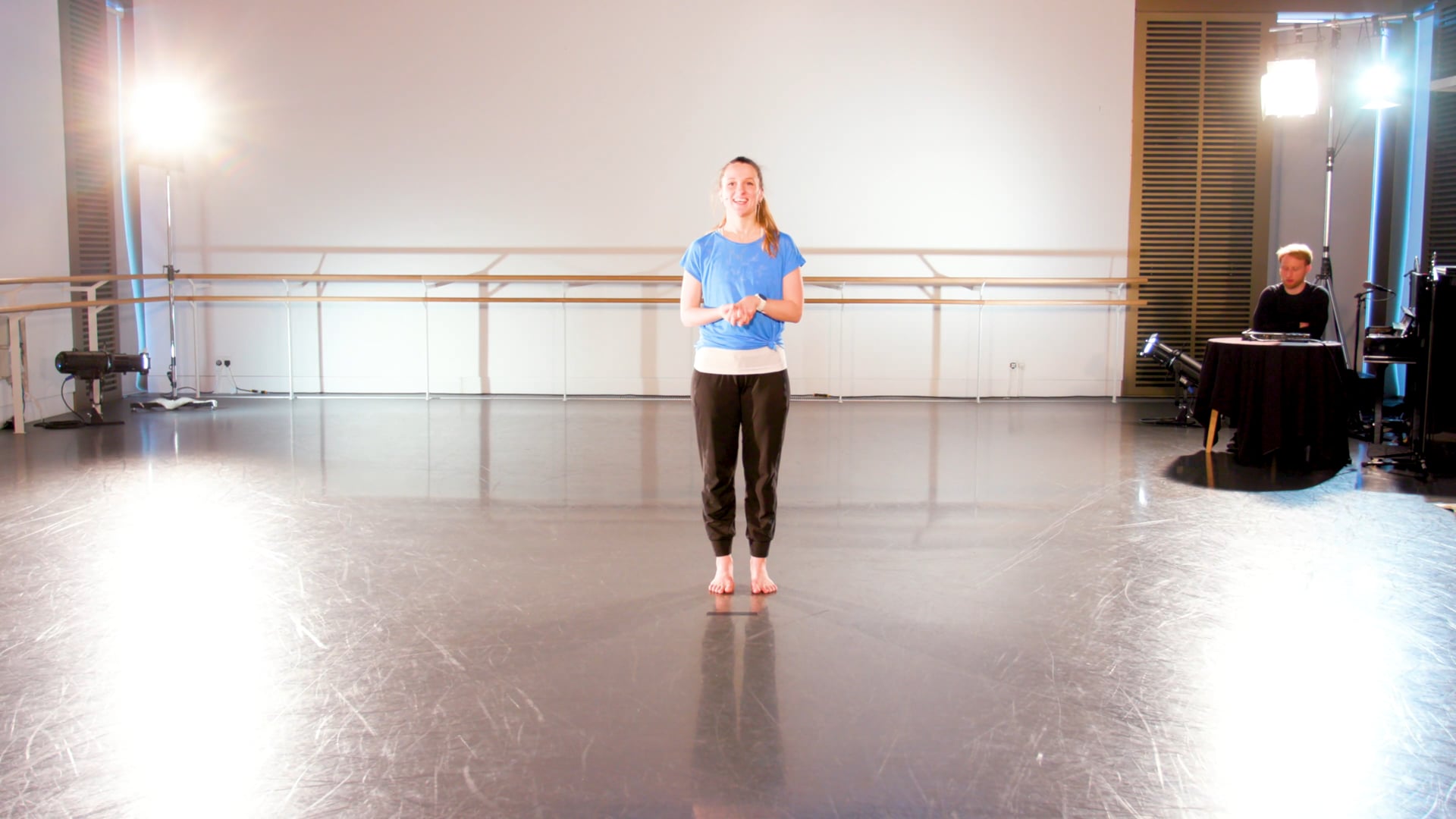 a woman standing on a stage in a room.