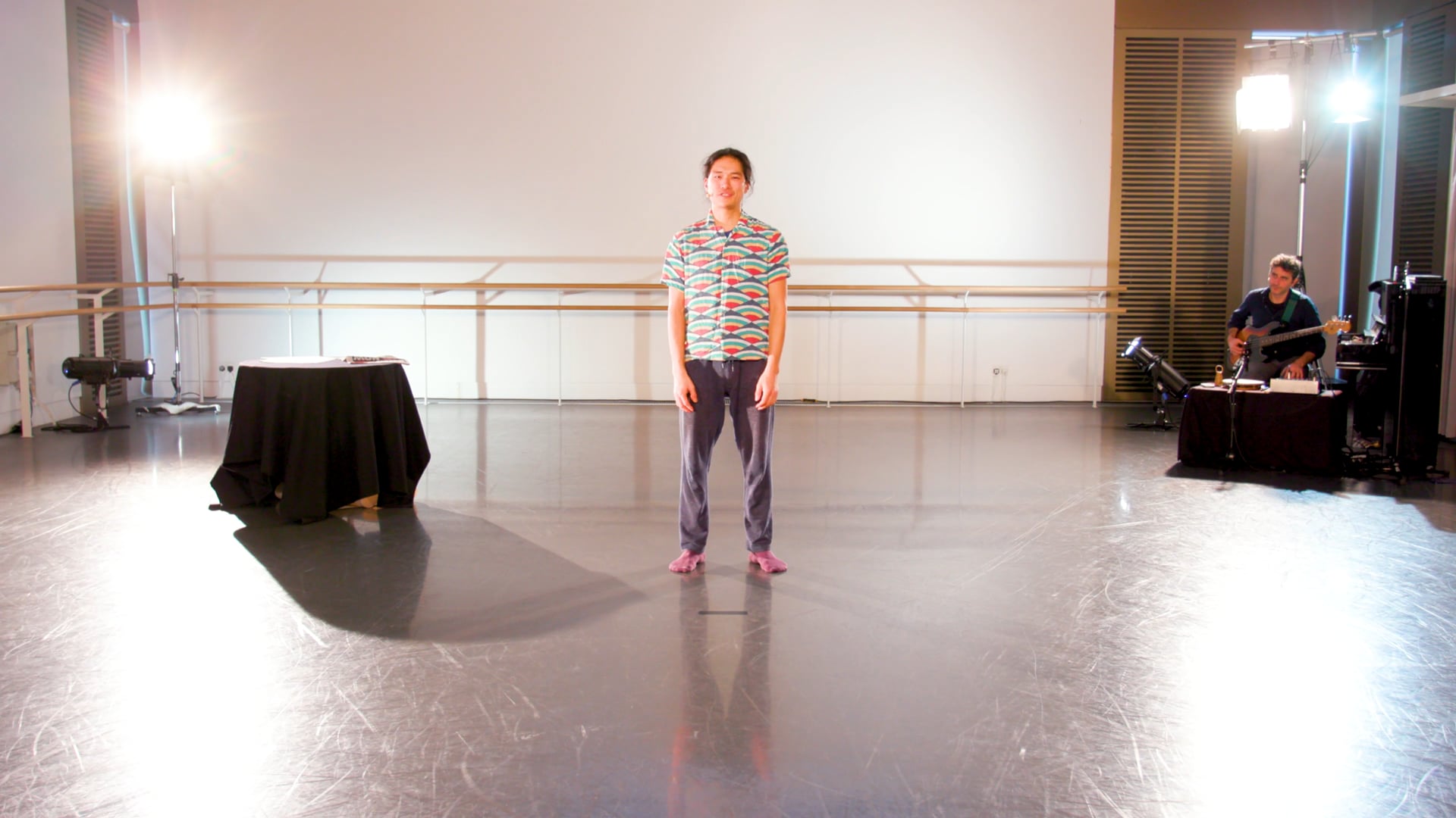 a person standing in a room with a black table.