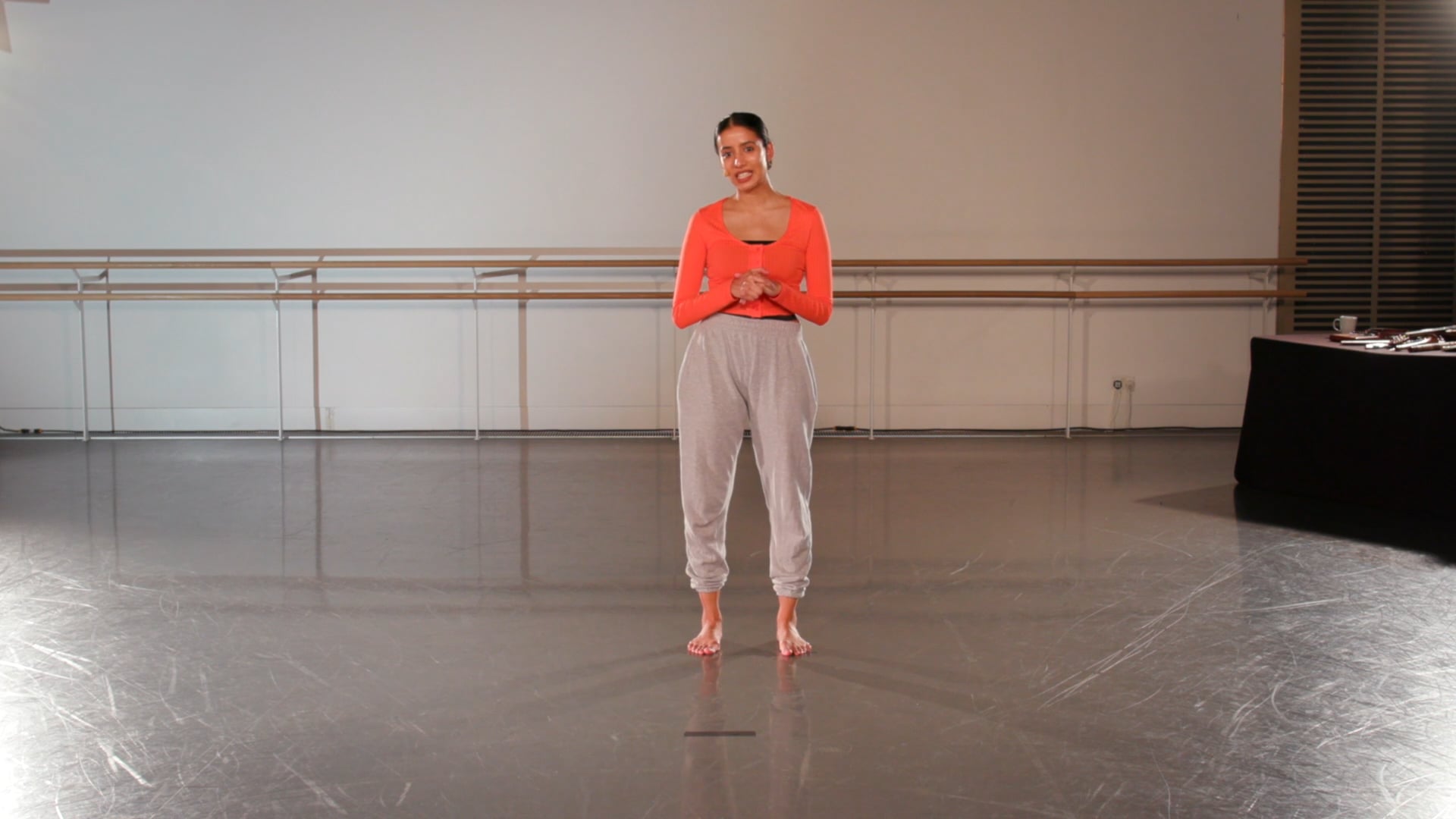 a woman is standing in a dance studio.