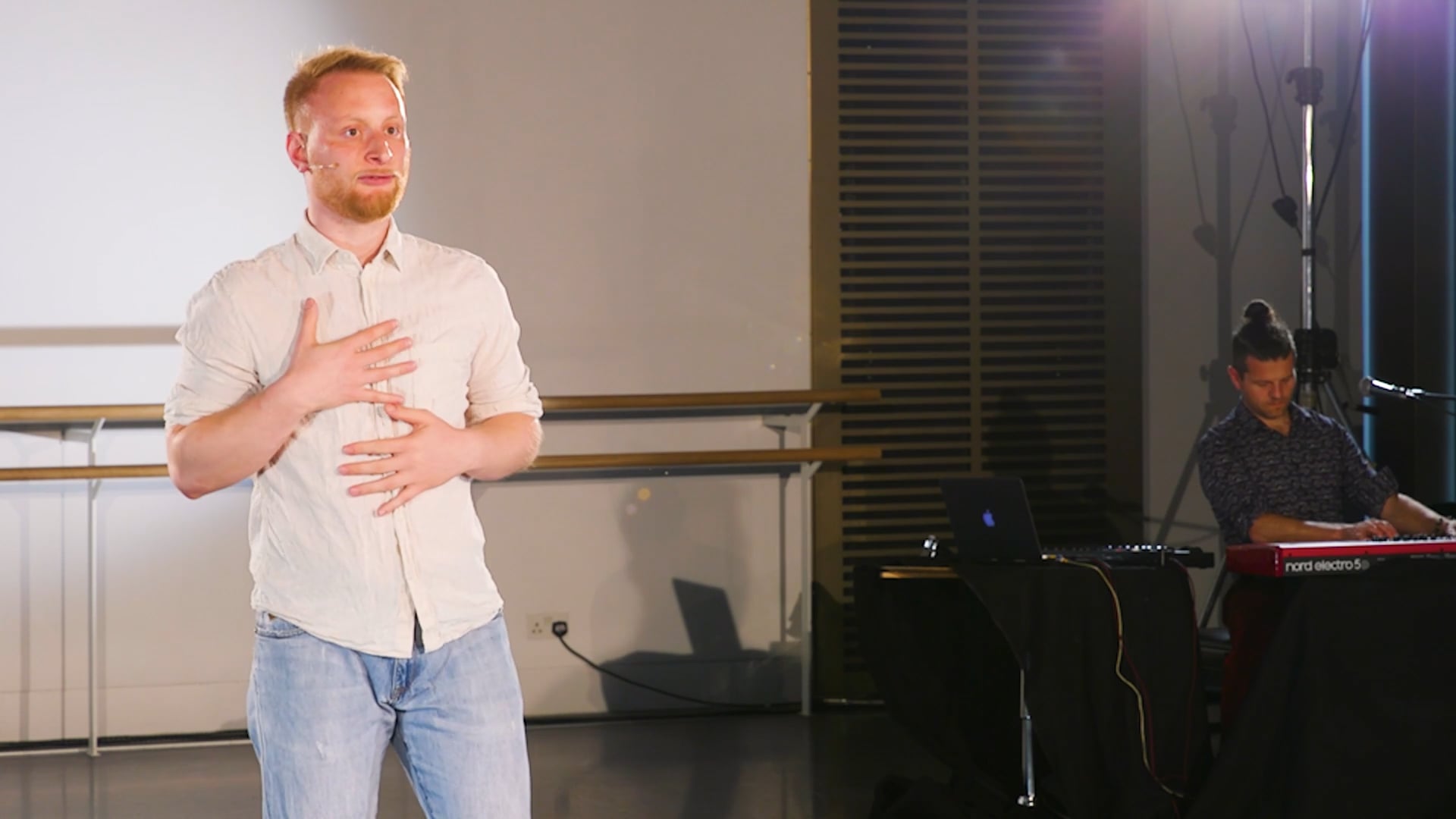 a man standing in front of a projector screen.