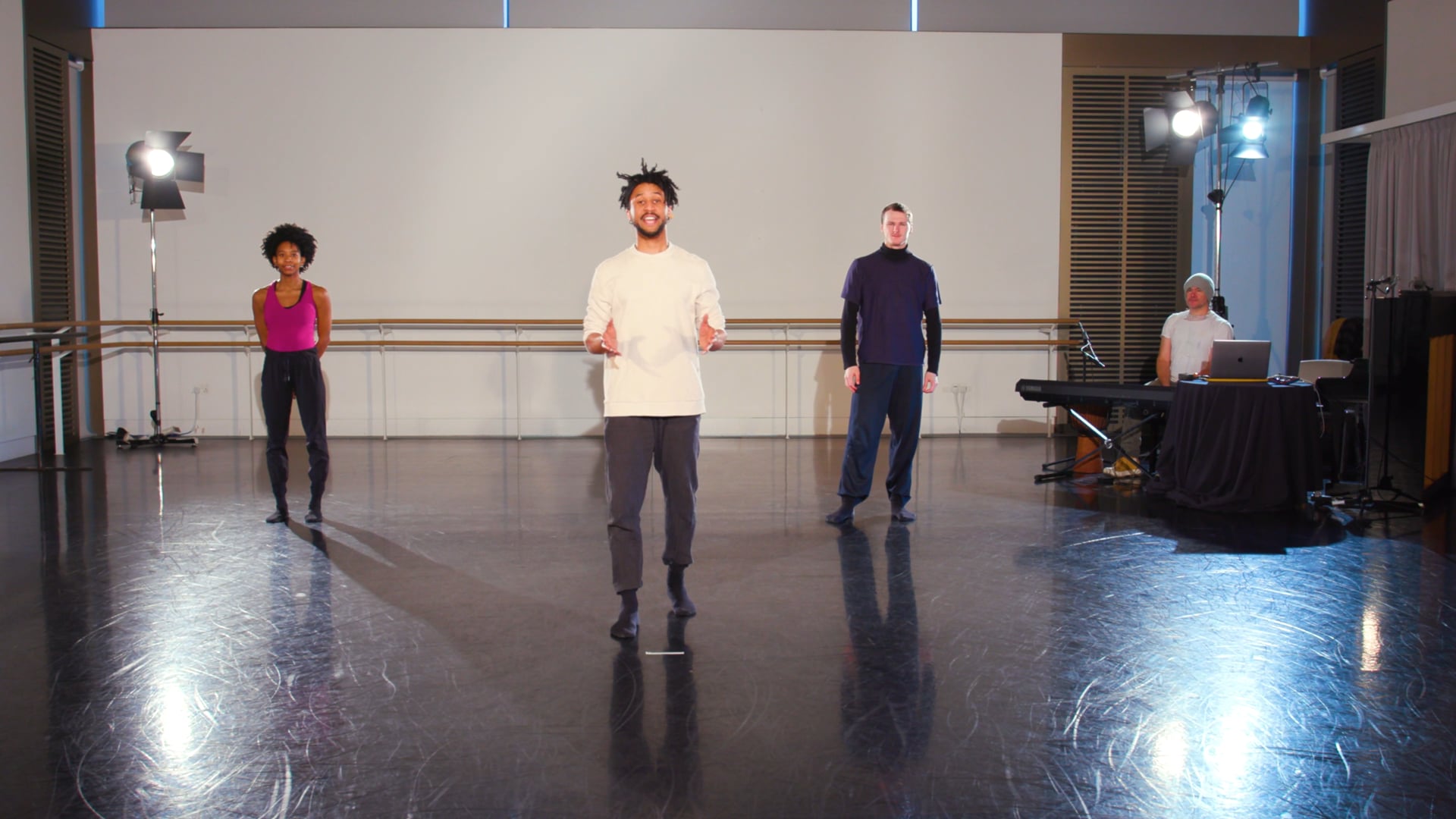 a group of people standing on top of a dance floor.