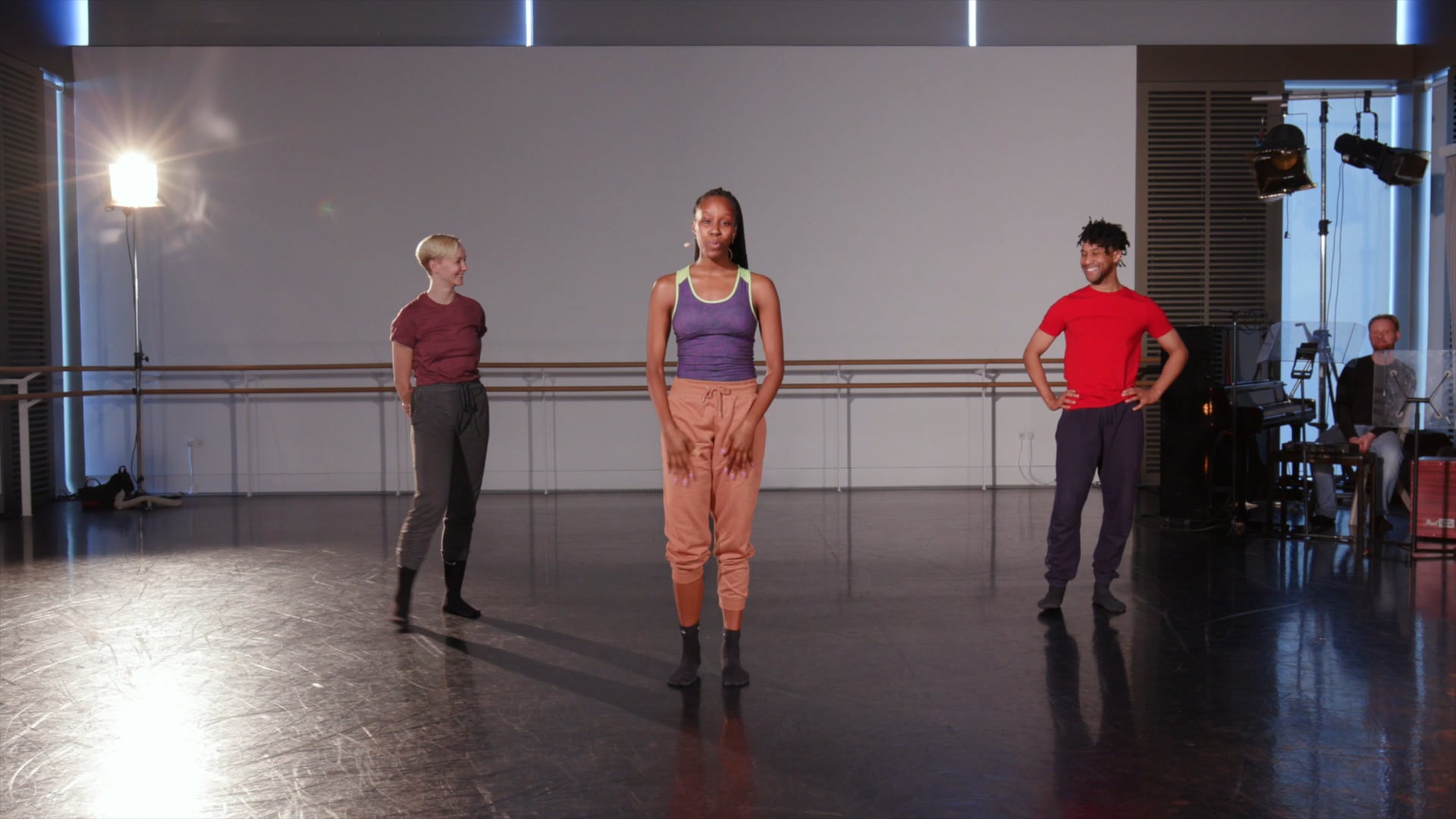 a group of people standing on top of a dance floor.