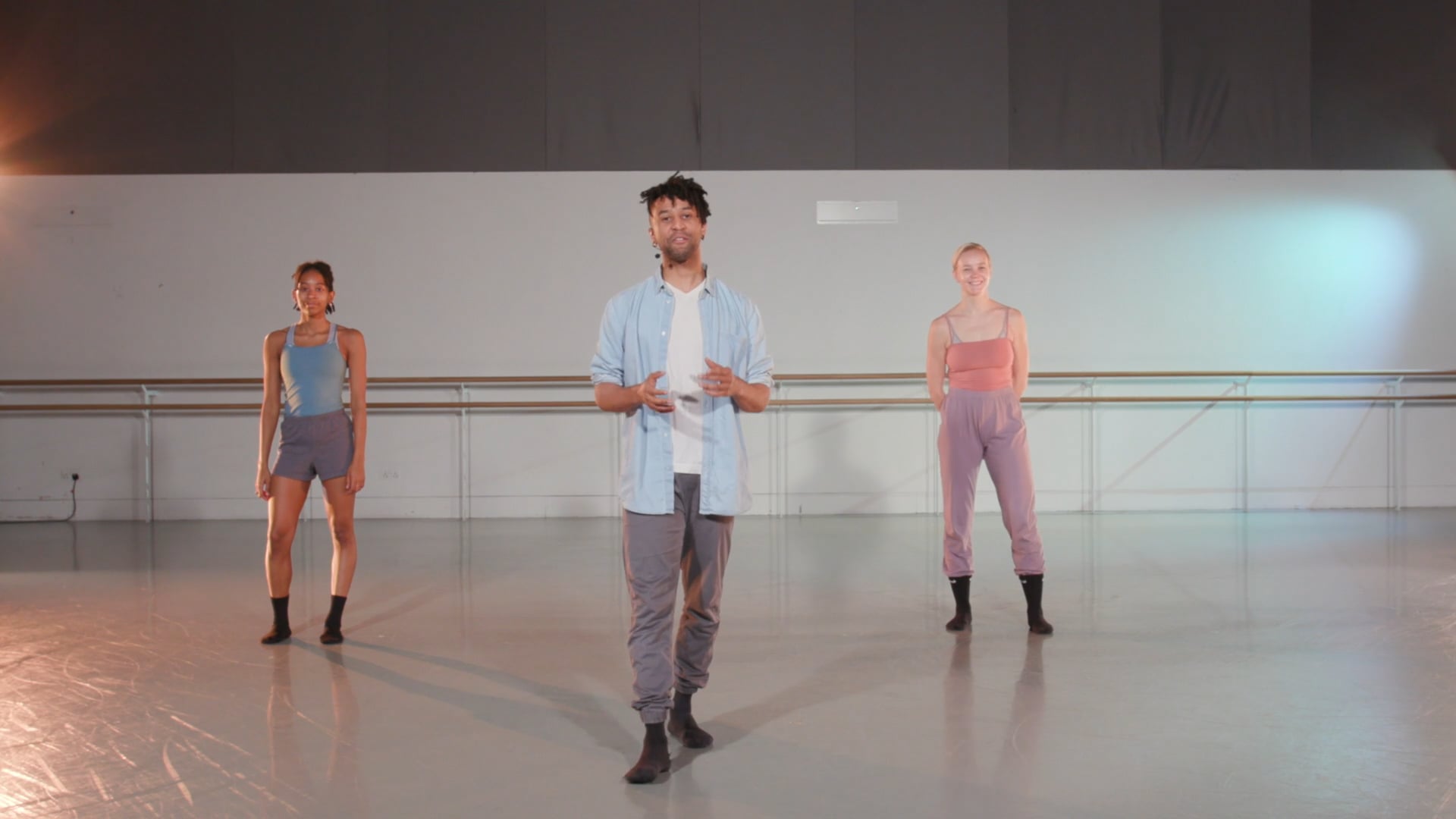 a man standing in front of a group of dancers.