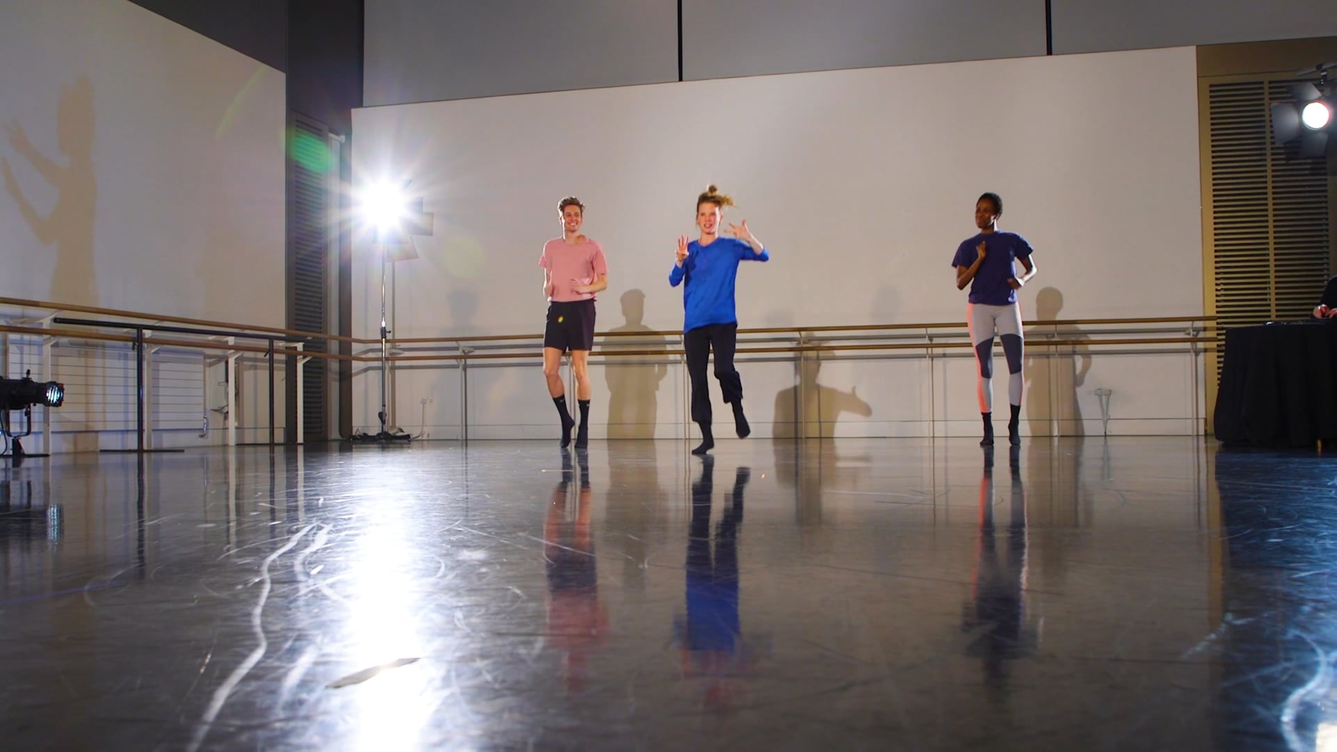 a group of people standing on top of a dance floor.