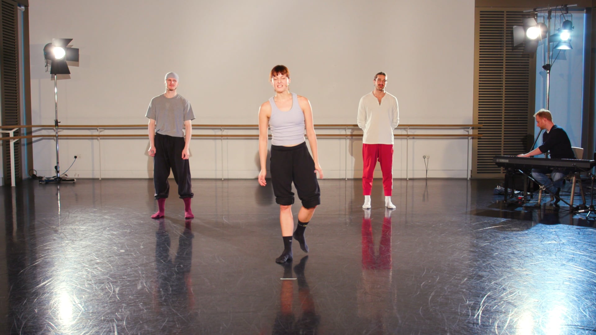 a group of men standing on top of a dance floor.