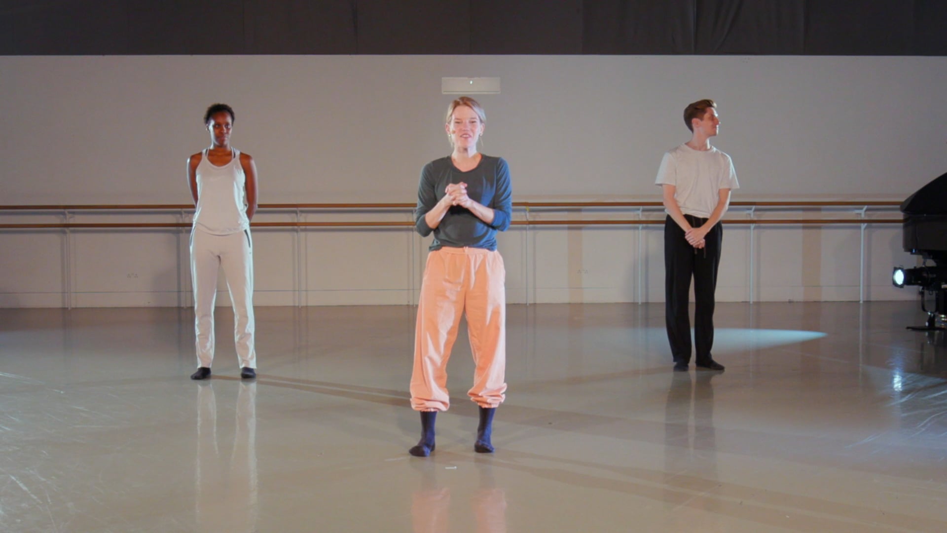 a group of people standing on top of a dance floor.