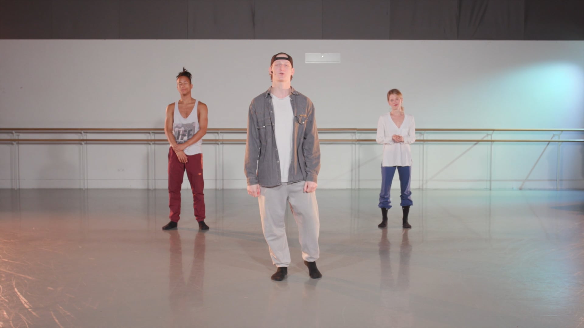 a man standing in front of a group of dancers.