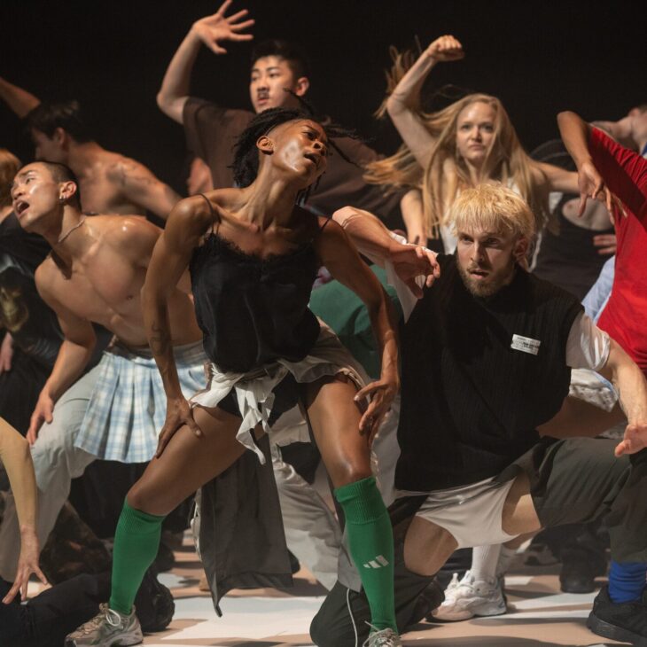 Rambert Dancers in the middle of performing Room With a View by (LA)HORDE. They are sweating and in motion on white flooring.