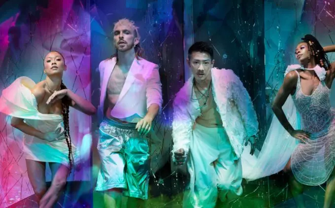 This is Rambert lead image with four dancers dressed in white looking at the camera and overlay colourful projections
